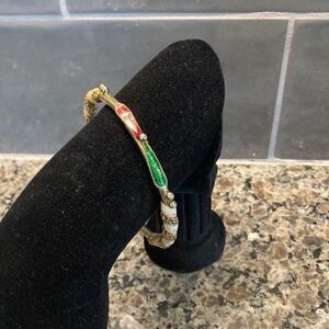 Beautiful ornate black, red, winter white, and gold tone bracelet